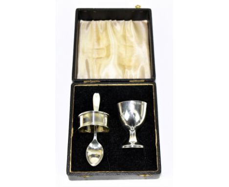 A hallmarked silver matched three piece christening set comprising egg cup, napkin ring and spoon, approx weight 1.7ozt/53g.A