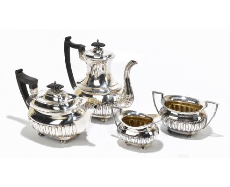 WALKER &amp; HALL; a late Victorian hallmarked silver four piece tea service with gadrooned decoration to lower body, raised 