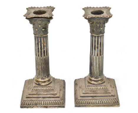 GOLDSMITHS & SILVERSMITHS CO; a pair of Victorian hallmarked silver Corinthian column candlesticks, Sheffield 1895 (weighted)