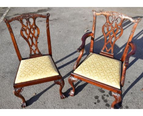 A set of twelve reproduction mahogany Chippendale style dining chairs each with carved top rail above pierced vase shaped spl