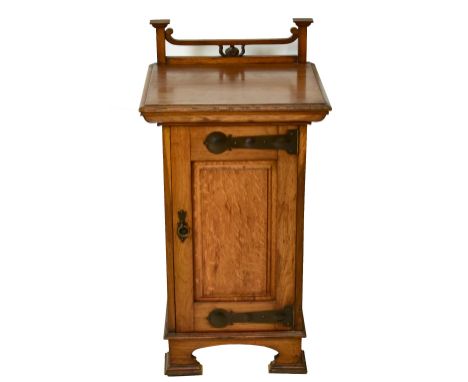 WYLIE &amp; LOCKHEAD OF GLASGOW; a circa 1900 oak Arts &amp; Crafts bedside cabinet with open raised back, strap hinges and s