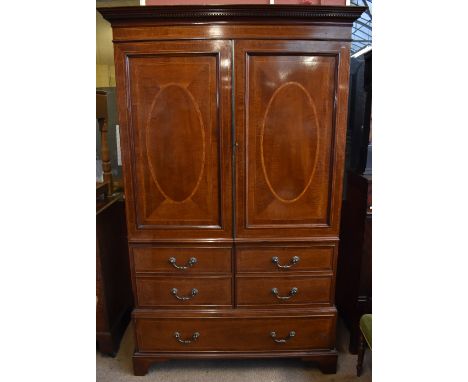 An Edwardian mahogany and inlaid wardrobe, the moulded dentil cornice above hanging space, with a single drawer to the plinth