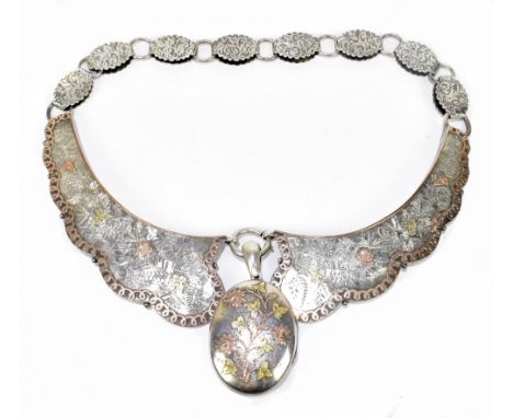 A Victorian white metal, yellow metal and rose coloured metal inlaid necklace with locket pendant drop beneath an unusual sha