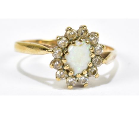 A yellow metal and opal and diamond ring, with oval opals surrounded by twelve diamonds, size O, approx 1.8g.Additional Infor