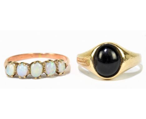 A 9ct yellow gold gentleman's signet ring set with oval black coloured stone, size P, and a yellow metal lady's dress ring se