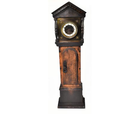 A late Victorian oak cased miniature longcase clock, with carved detail to the hood, the brass dial with circular chapter rin