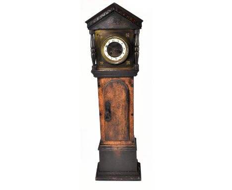 A late Victorian oak cased miniature longcase clock, with carved detail to the hood, the brass dial with circular chapter rin