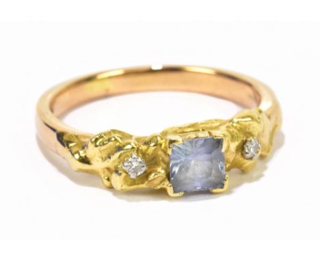 A contemporary 18ct yellow gold dress ring set with twin tiny diamonds and centred with a blue stone, size R, approx 5.8g.Add