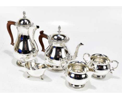 BARKER ELLIS &amp; CO; an Elizabeth II hallmarked silver four piece tea service comprising teapot, hot water pot, a twin hand