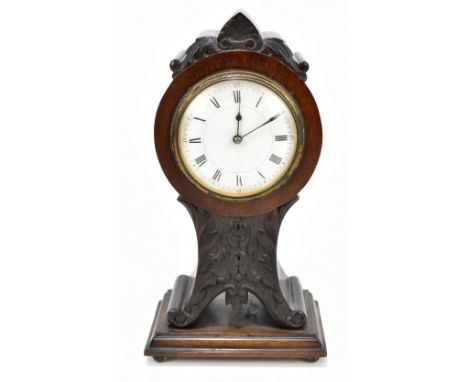 A late 19th century French mahogany mantel clock with carved floral detail, the circular dial set with both Arabic and Roman 