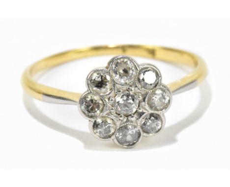 A yellow metal mounted daisy set diamond ring, set with nine diamonds, approx size S 1/2.Additional InformationThe marks are 