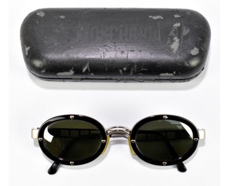 MOSCHINO; a pair of vintage medium sized round black sunglasses with dark lenses and silver tone arms with logo to sides.Addi