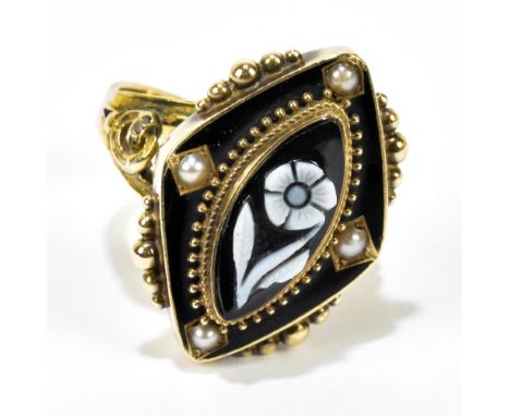 A Victorian yellow metal, black enamel and seed pearl mourning ring centred with a carved cameo style lozenge shaped floral s