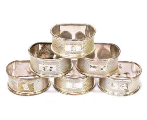 W.I. BROADWAY &amp; CO; a set of six Elizabeth II hallmarked silver napkin rings, each with engine turned decoration flanking