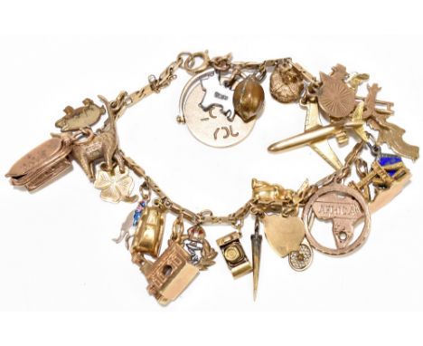 A 9ct yellow gold charm bracelet set with numerous charms including an aeroplane, map of Africa, cat, Noah's Arc, etc, gross 