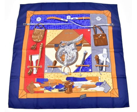 HERMÈS; a 100% silk 'Tout Cuir (All Leather)' scarf, signed by Cathy Latham, 2002, edged with a blue border and coloured brow