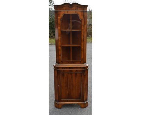 A reproduction walnut free standing corner cupboard, 187 x 40 x 85cm.Additional InformationLight wear and minor scratches thr