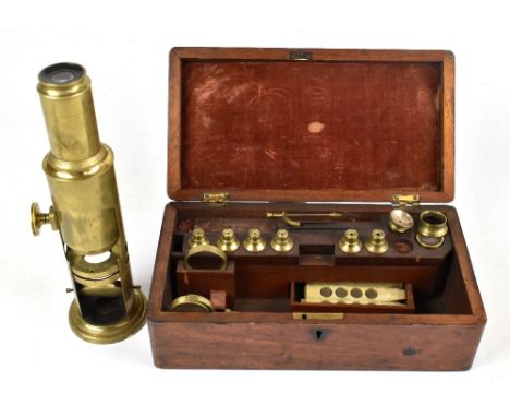A 19th century mahogany cased brass cuff type microscope with several lenses and attachments to the case, the microscope heig