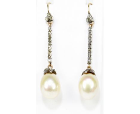 A pair of early 20th century Edwardian diamond and pearl drop pierced earrings with a three diamond stone top, a run of ten t