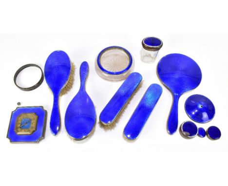 A George V hallmarked silver and blue guilloche enamel decorated dressing table set with some base metal elements including a