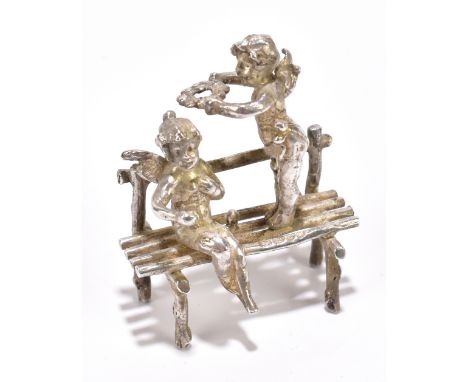 A late Victorian hallmarked silver miniature model of two cherubs on a bench, with import marks for London 1899, approx weigh