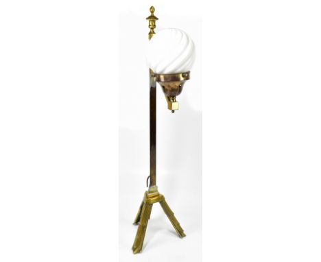 A brass lamp with white opaque wrythen moulded globular shade, height 84cm.Additional InformationPlease note this is a Heath 