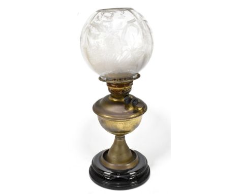 An early 20th century brass oil lamp, with clear glass shade with etched floral decoration, overall height 48cm.Additional In