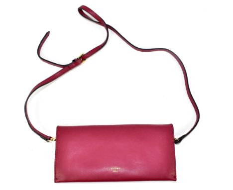 CELINE; a burgundy red and blue calfskin leather shoulder/clutch bag with detachable shoulder strap/gold tone circular front 