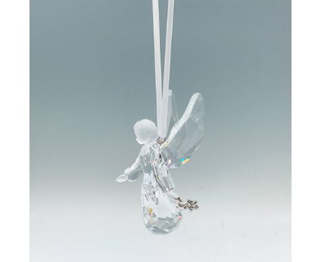 Part of the Season collection. A angelic tree ornament of an angel made from clear and matt crystals. She is holding silver-t