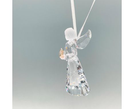 A angelic tree ornament of an angel made from clear and matt crystals. She is holding a golden shadow crystal star. Swarovski