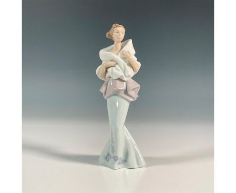 Glossy finish figure of a lady in a light blue mermaid style dress with white shawl. Lladro backstamp. This item has its orig