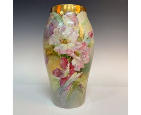 A beautiful vase with hand painted pink flowers. Decorative gilded trim on the top. Tressemanes &amp; Vogt marked on the unde