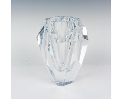 A clear crystal vase with smooth texture cuts throughout the design with an entrance that reaches about three quarters of the