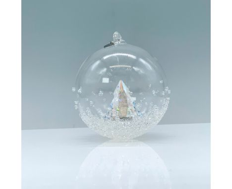 A clear crystal Christmas ball ornament adorned with dazzling crystals that contains a pine tree in its center and a rhodium 
