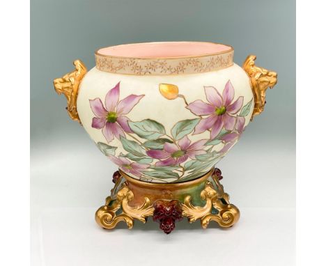 Matte porcelain vase decorated with hand-painted purple, white and yellow flowers with green leaves; gold rim, accents. Two g