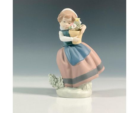 Matte finish figure of a young village girl holding a pot of flowers with her clothes blowing in the winder. Lladro backstamp