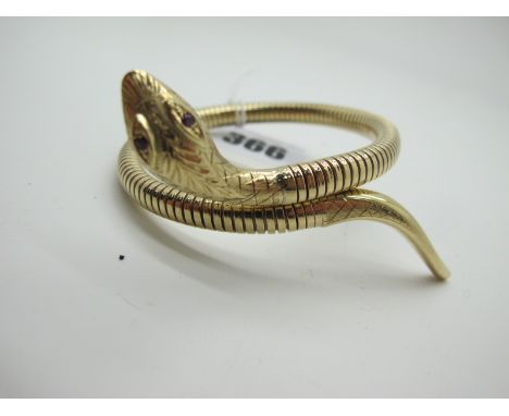 A Modern 9ct Gold Snake Style Bangle, textured finish, with inset eyes, stamped "Steel Spring".
