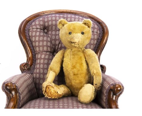 A German teddy bear 1910-20s, with golden mohair, black boot button eyes pronounced muzzle, slotted-in-ears, swivel head, joi