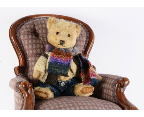 A post-war Chiltern Hugmee teddy bear,  with orange and black glass eyes, swivel head, jointed limbs with velvet pads --14in 