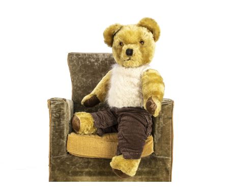 A 1960s Pedigree teddy bear,  with golden mohair, orange and black plastic eyes, ears with bells, black stitched nose and mou