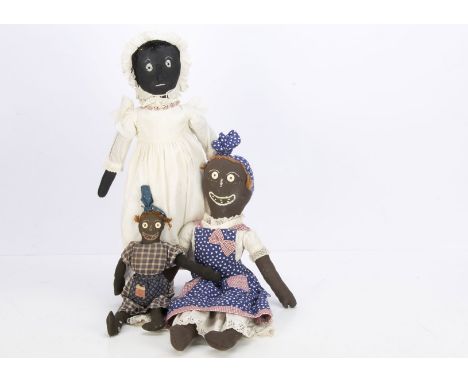 Three recent black cloth dolls in the primitive antique style, with stitched features, two with button eyes, two with light g