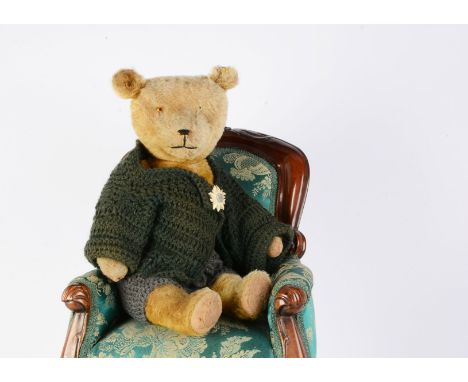 A German 1920s  teddy bear,  with glass eyes, slotted-in-ears, swivel head and jointed limbs with felt pads --20in (51cm.) hi