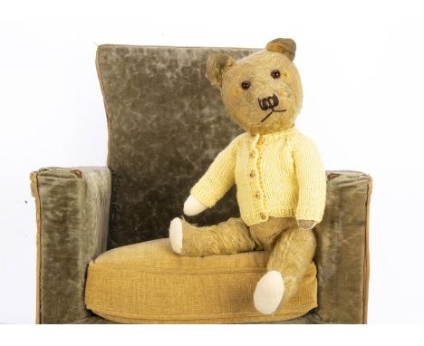 A post-war Chiltern Hugmee teddy bear,  with golden mohair, orange and black glass eyes, black stitched nose and mouth, swive