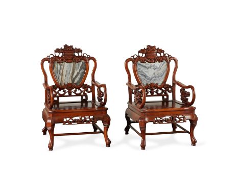 Pair of Chinese Anglo Export carved wood armchairs with scrolling arms and legs and a dragon motif. Each with a marble panel 