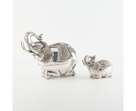 Group of two Cambodian silver betel nut boxes in the form of elephants. Their trunks are raised above their heads and they re