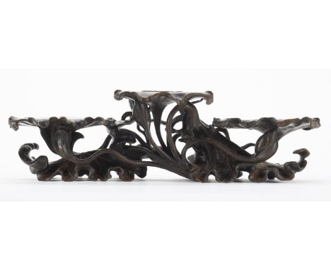 Chinese three platformed rosewood stand. Carved to resemble lily pads with undulating leaves underneath.Height: 7 in x width: