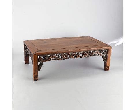 Chinese carved hardwood stand. With an intricately carved and pierced skirt depicting scrolling leaves and fruit. Resting on 