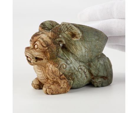 An antique Chinese jade carving depicting a beast, possibly a chimera. The carving has a cup along the back of the figure.Hei