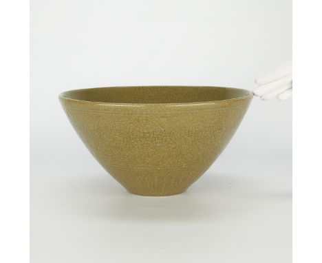 Large antique Chinese stoneware bowl with a green crackle glaze and impressed designs in a band along the lower edge and top 