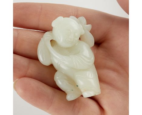 A well-carved piece of Chinese white jade depicting a boy holding a lotus.Length: 2 in x width: 1 1/2 in x depth: 3/4 in.Cond